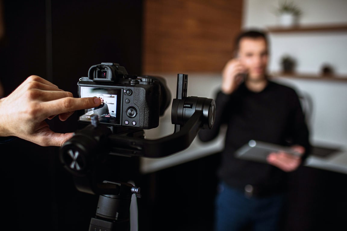 Cameraman Recording Video of Young Businessman 